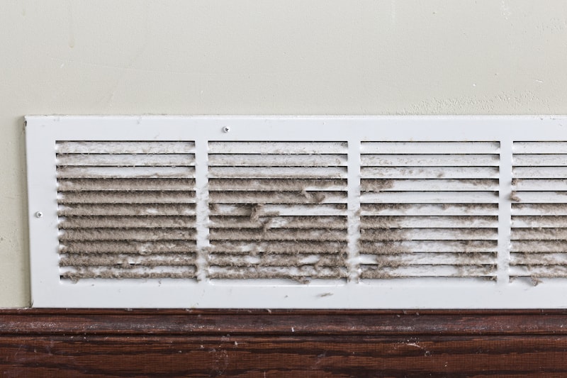 vent showing that the dust is over accumulating in the air ducts and is now pushing through the vent covers.